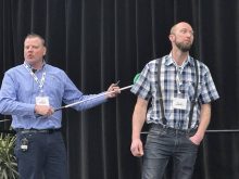 Olymel’s Kevin Brooks (right) explains how to properly position a rattle bat during the Manitoba Swine Seminar Feb. 5, using a member of the audience as an example.