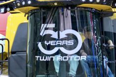 A pair of farmers check out the cab of New Holland’s CR10 combine at the 2025 National Farm Machinery Show in Louisville, Kentucky. 