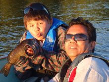 Chase Ganaden and his father, Ben, with a bass taken on a bobber. 