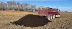Kyle Heggie spreads compost on a field. Heggie hopes to instead place pellets made from compost inside the seed row.