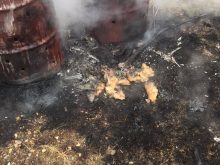 Fire escapes a burn barrel intended to contain the flames.
