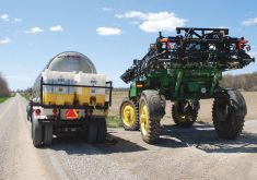 A sprayer loads up its tank of agricultural chemical on a western Canadian farm.