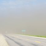 A truck disappears into a bank of dirt whipped up by strong winds near Altamont, June 16, 2024.