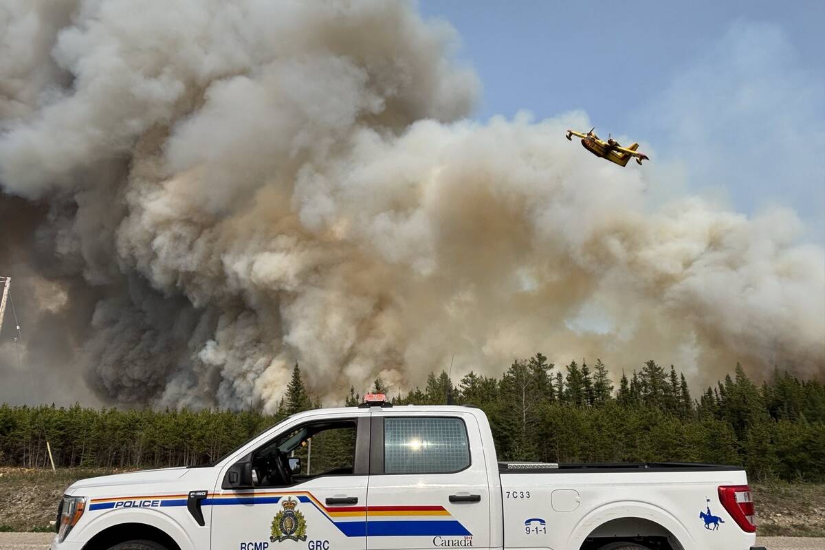 Smoke rises off a raging wildfire in northern Manitoba May 30.