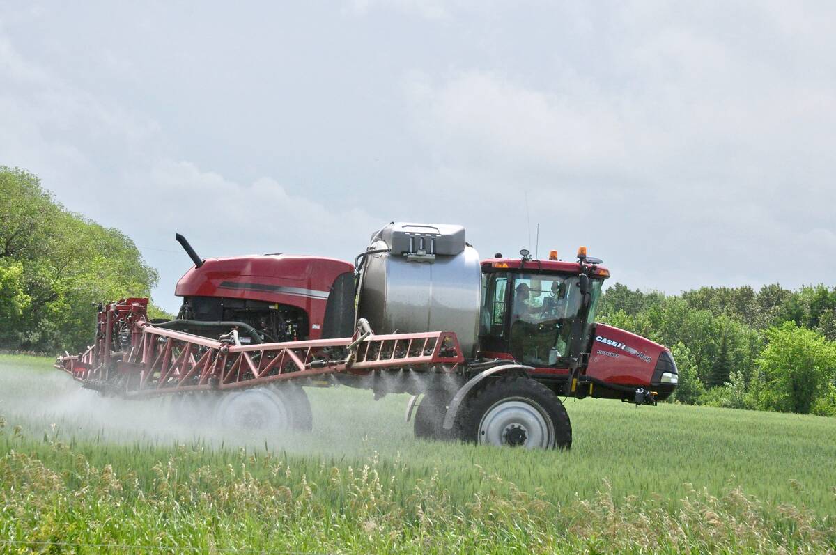 A farmer in central Manitoba applies fungicide against fusarium head blight.