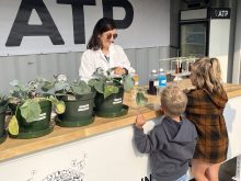 Photo by Greg Price
Barbara Hodecker, director of research and development for ATP Nutrition shows youth Blair and Eleanor Uruski how biostimulants help plants handle abiotic stress like drought.
