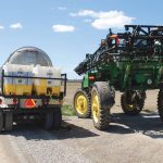 A sprayer loads with a pesticide tank mix on the side of a road. PHOTO: FILE