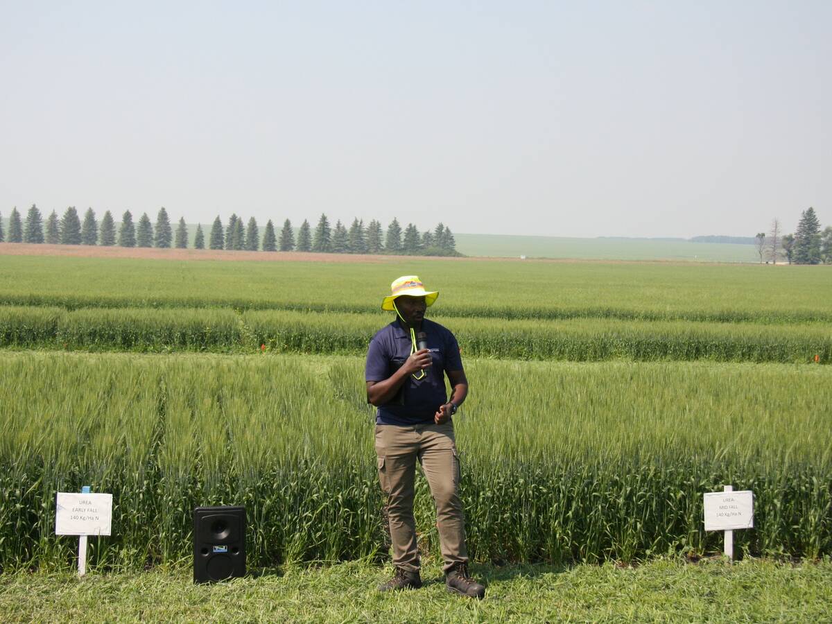 Patrick Mooleki, Agriculture and Agri-Food Canada research scientist, speaks about nitrogen research in front of barley plots in Melfort, Sask. Photo: Janelle Rudolph