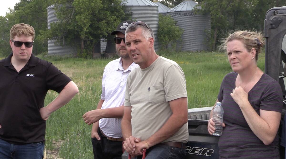 Scott Duguid (centre) speaks during a grazing management tour on his farm near Arnes, Man., on July 30. Photo: Greg Berg