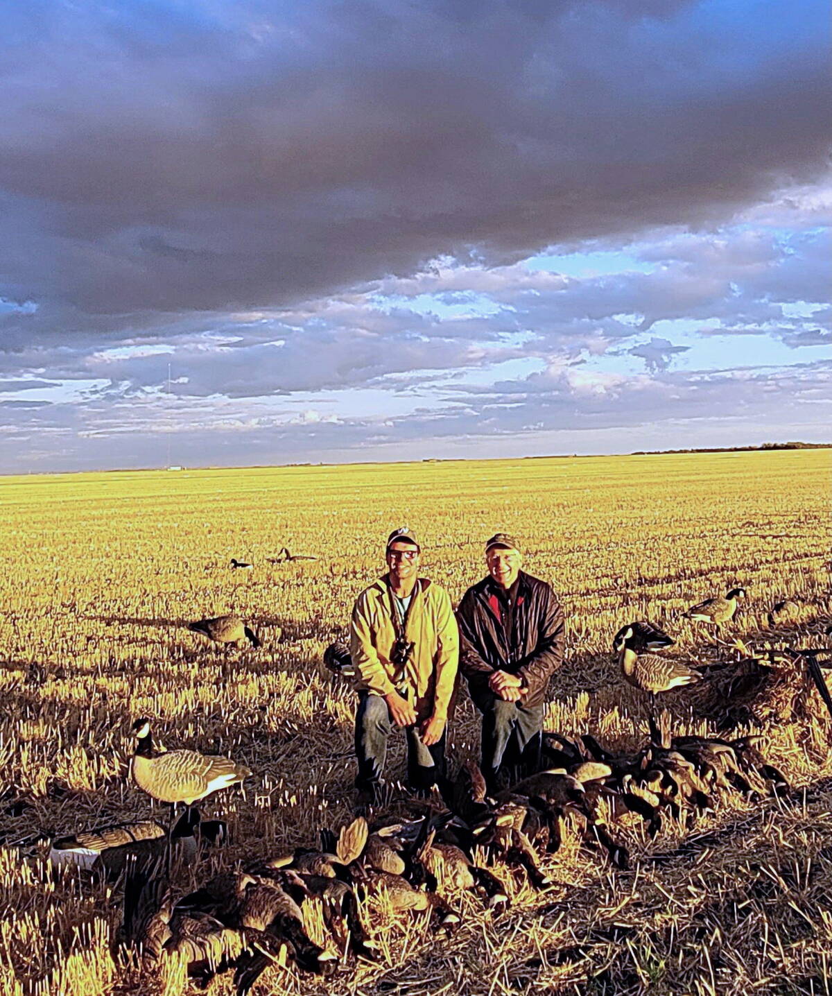 Rob Olson (left) and Tim Sopuck bathed in evening light after an excellent Canada goose field hunt. Photo: Warren Bernhardt