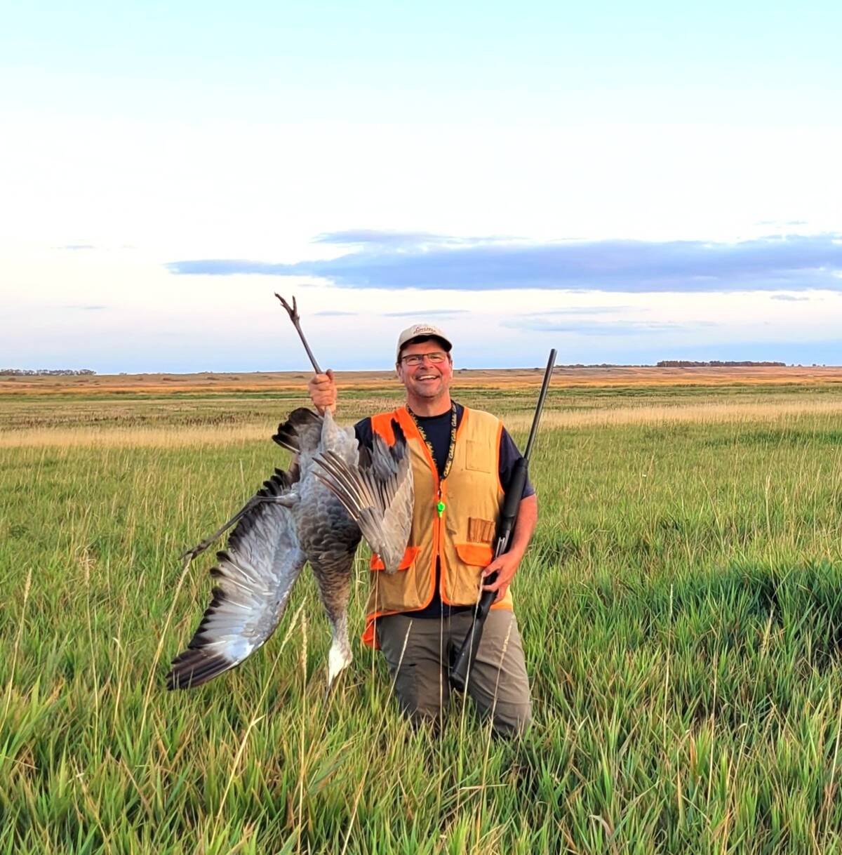Rob Olson, pictured here with a sandhill crane, has spent decades honing his waterfowl hunting skills. Photo: Tim Sopuck