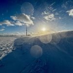 Ice crystals and snow whipped up by winter winds catch the sun near Russell, Man.