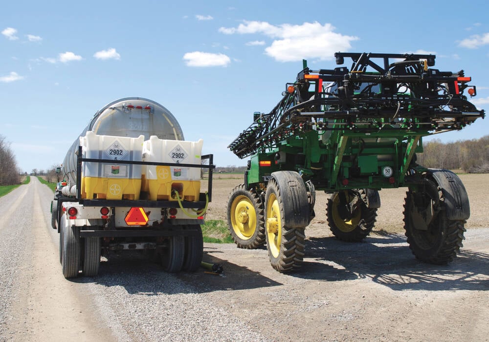 A sprayer loads with a pesticide tank mix on the side of a road. PHOTO: FILE