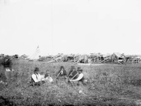 Antique photograph of a Metis traders' camp in 1879 with Red River carts in background. Dr. Robert Bell/Library and Archives Canada/PA-039926
