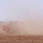 a red tractor obscured in dust while working in dry soils. Pic: Alexis Stockford
