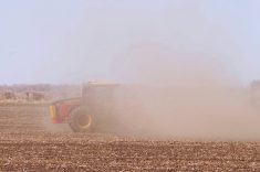 a red tractor obscured in dust while working in dry soils. Pic: Alexis Stockford
