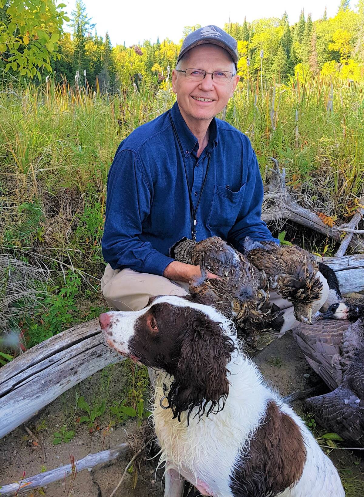 Tim Sopuck with a pair of ruffed grouse flushed and retrieved by his spaniel, Niska. Photo: Tim Sopuck
