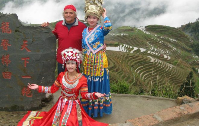 Philippe Sabourin poses with locals in front of rice terraces in China. 
