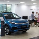 FILE PHOTO: Customers speak with a salesman at a BYD dealership in Sant Cugat del Valles, near Barcelona, Spain, September 12, 2025. REUTERS/ Albert Gea/File Photo