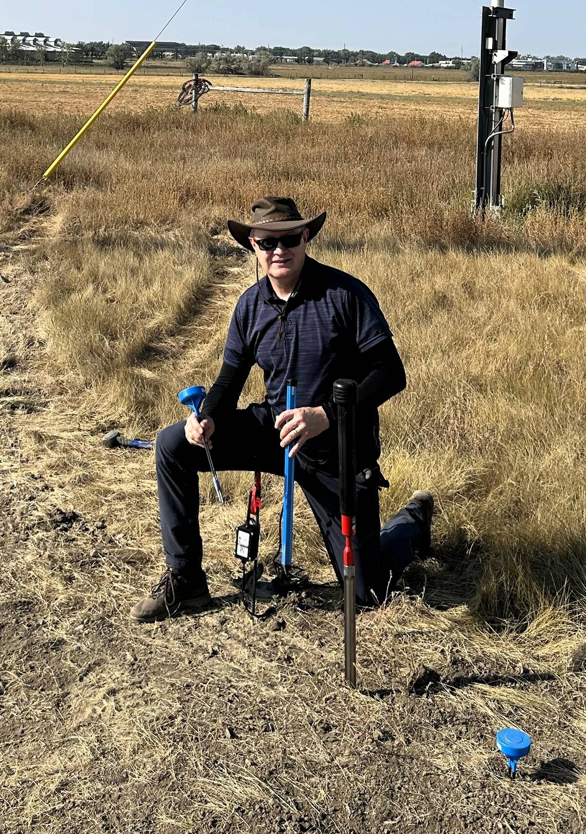 Trevor Coates, agricultural meteorologist and research scientist with Agriculture and Agri-food Canada, inserts sensors into the soil. These sensors can bring information which can be fed into smart technology to give measurements about soil moisture and temperature in real time. Photo: Agriculture and Agri-food Canada