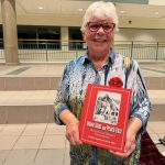 Bonnie Setter holding her book 'Onion skins and peach fuzz' at a screening of the We Lend a Hand documentary in Strathroy, Ont. Photo: John Greig 