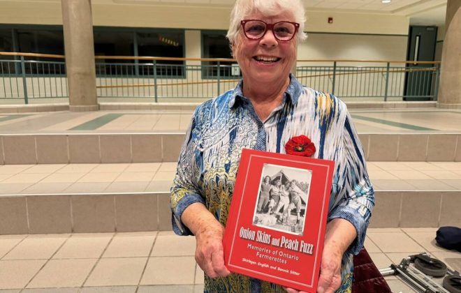 Bonnie Setter holding her book ‘Onion skins and peach fuzz’ at a screening of the We Lend a Hand documentary in Strathroy, Ont. Photo: John Greig
