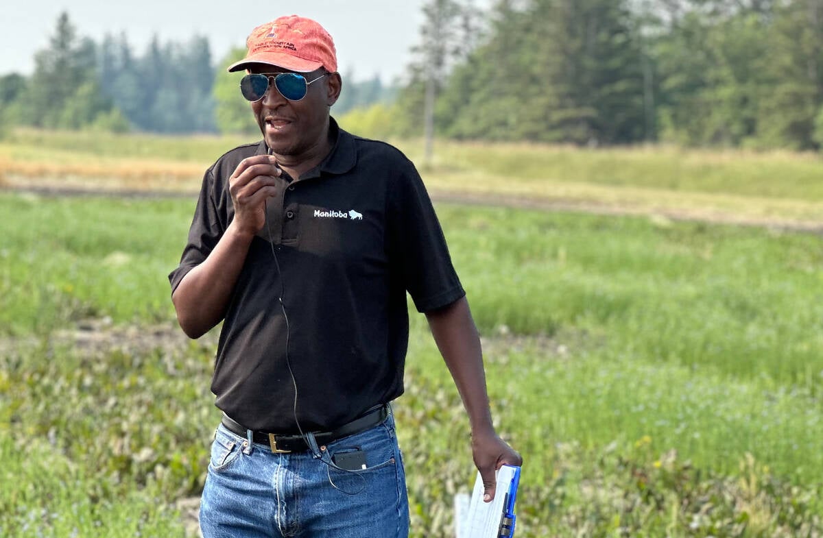 Manitoba Agriculture's Manasah Mkhabela at Arborg, Man. in July 2025, discussing trials he's conducting with University of Manitoba soil scientist Mario Tenuta to find the sweet spot for nitrification inhibitors. Photo: Don Norman