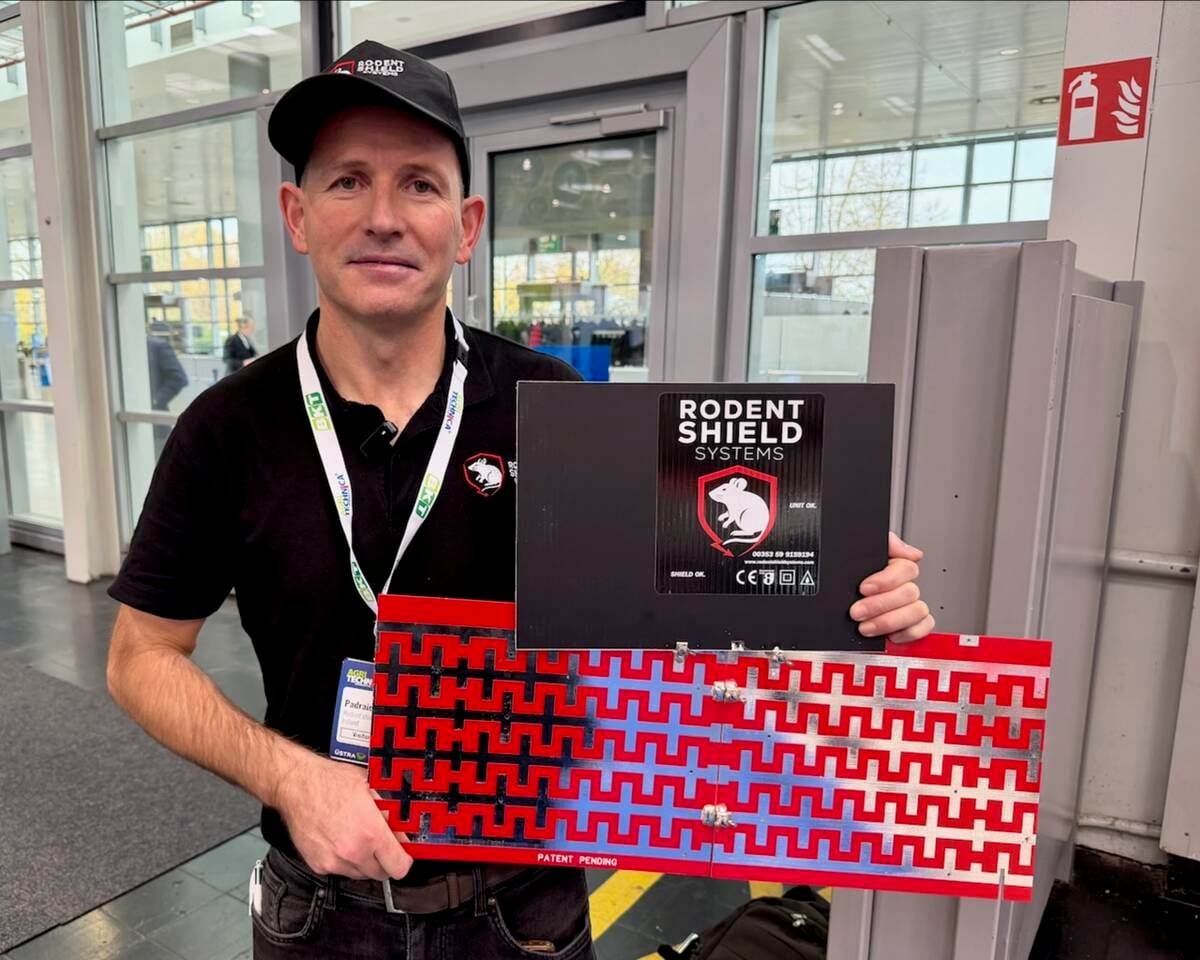 Padraic George shows the fence system he developed to keep rodents out of combines. Photo: John Greig