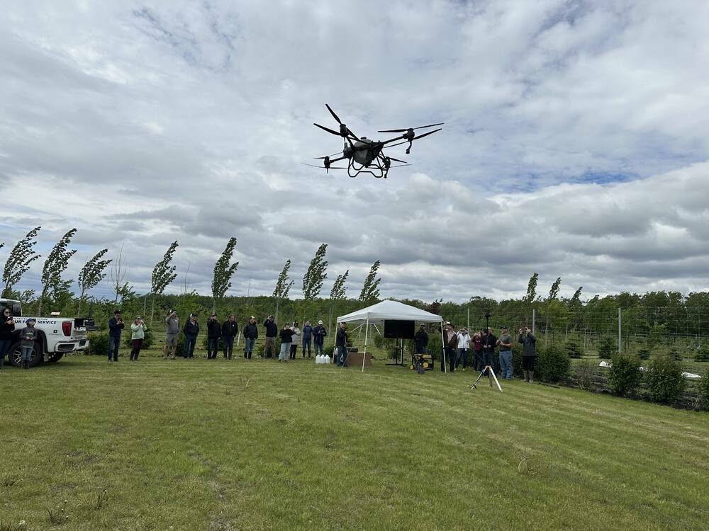 Farmers watch a drone demonstration at summer 2025 field day in Manitoba. Photo: File