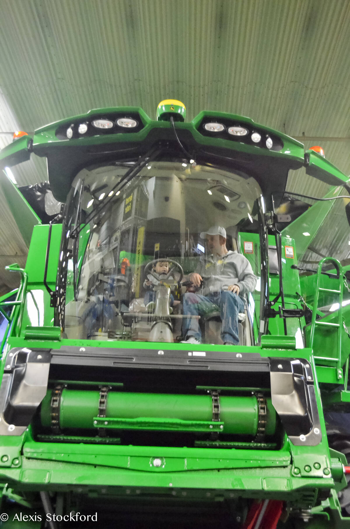 Wes Martens (right) of Killarney takes the next generation into the combine cab at Manitoba Ag Days 2018 in Brandon. Photo: Alexis Stockford