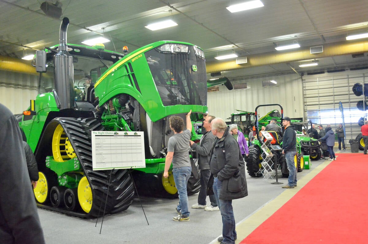 Manitoba Ag Days attendees take the chance to look under the hood at the equipment booths of major dealerships and machinery manufacturers during the 2018 show in Brandon. Photo: Alexis Stockford