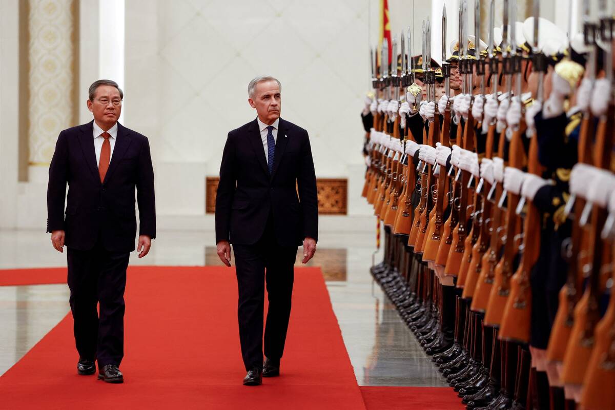 Canada’s Prime Minister Mark Carney and China’s Premier Li Qiang review the honour guard at an official welcoming ceremony, during the first visit by a Canadian prime minister to China since 2017, at the Great Hall of the People in Beijing on Jan. 15, 2026. Photo: Carlos Osorio/Reuters