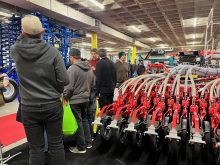 Farmers check out the latest planter offering from P&ouml;ttinger during Manitoba Ag Days 2026 in Brandon. Photo: Alexis Stockford