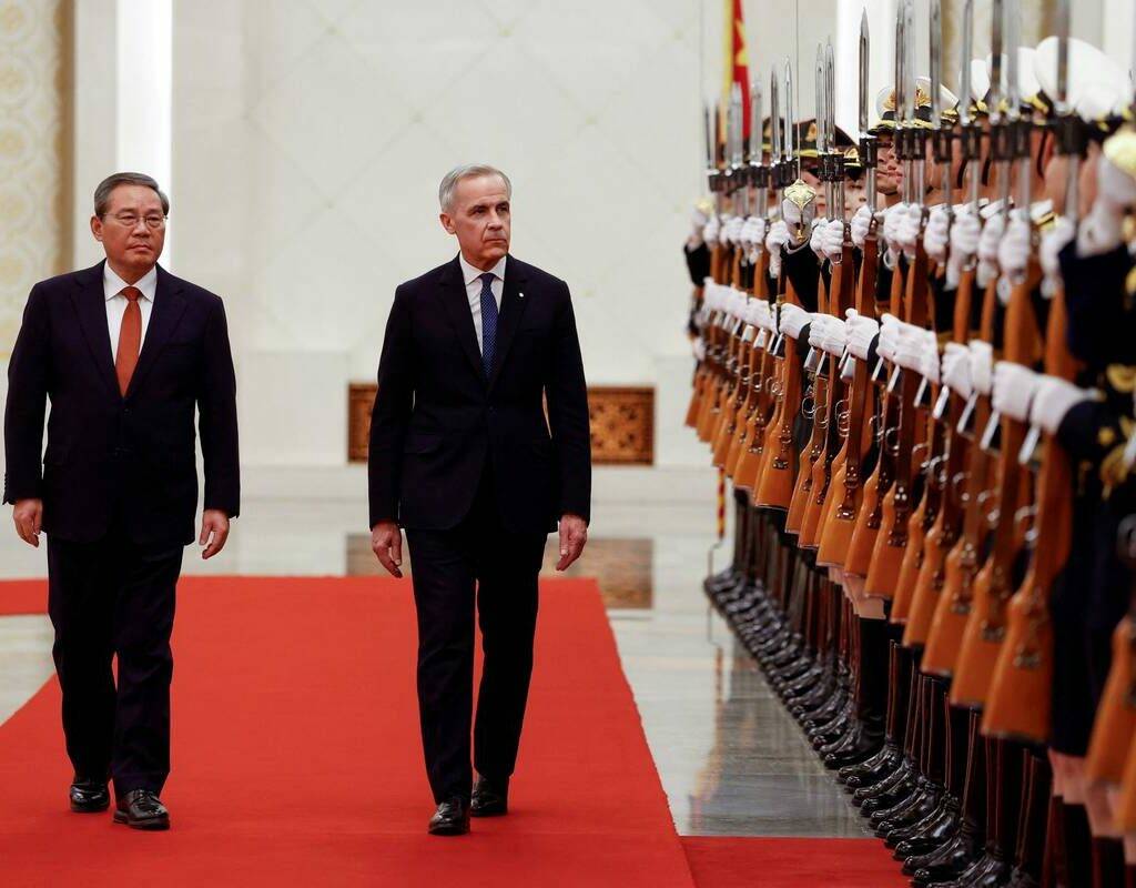 Prime Minister Mark Carney and China’s Premier Li Qiang review an honour guard in Beijing on Jan. 15, 2026. Agreements to improve trade in Canadian canola, beef and pulses have followed from Carney’s meetings in China. Photo: Reuters/Carlos Osorio