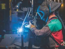A welder at work at the Deere manufacturing plant at Moline, Illinois. Photo: Deere and Co.