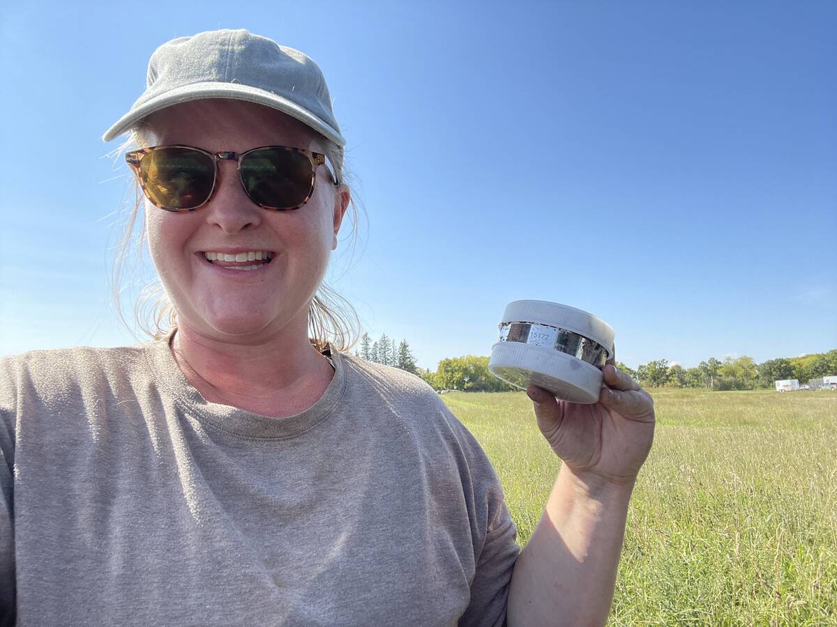 Research scientist Kayla Moore holds a Real-Time In-Situ Monitoring for Agriculture (RISMA) sensor, which can track moisture in the soil down to one metre. Photo: Submitted
