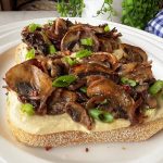 Leftover hummus and a handful of mushrooms make the most delicious toast. Photo: Getty Stewart