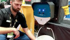Chris Hendrickson with Prairie Grain Analyzers runs a grain sample through the Auger Sampler device at Manitoba Ag Days.  Photo: Greg Berg