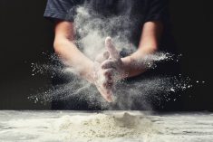 Clap hands of baker with flour in restaurant kitchen. YaroslavKryuchka/Getty Images