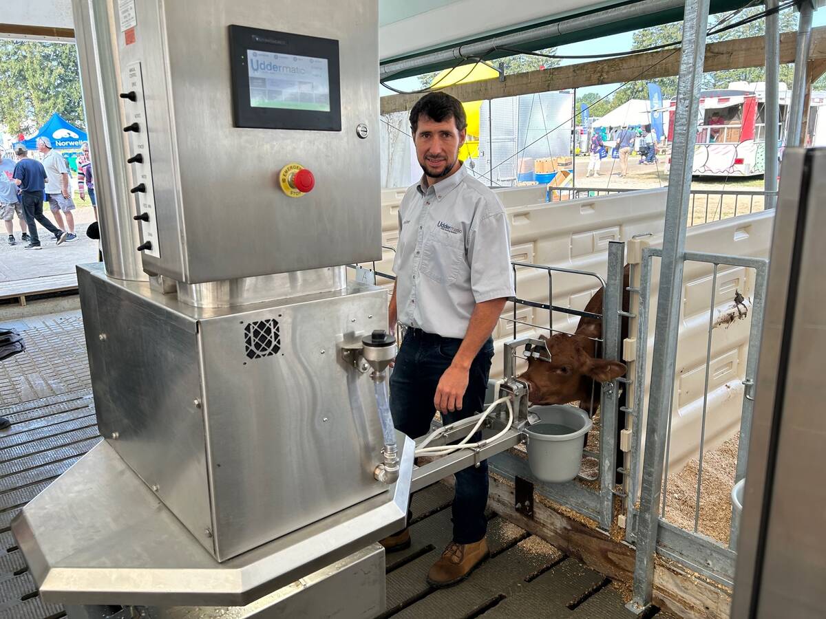Lester Martin stands with the Uddermatic automated calf-feeding system that he designed. This is the second year that a fully operating system &ndash; feeding Martin&rsquo;s own veal calves from his Mildmay-area farm &ndash; has been in place at the Dairy Innovation Centre during Canada&rsquo;s Outdoor Farm Show. Photo: Stew Slater 