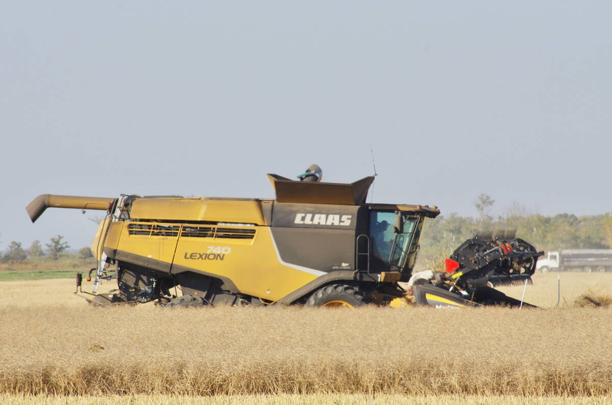 A Claas 740 Lexion combine harvester working through a field of mature, brown crops during harvest. Photo: Alexis Stockford