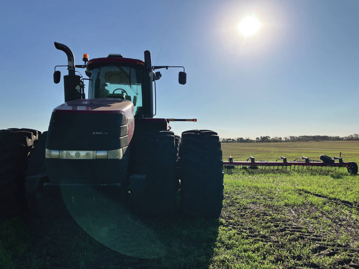 A close-up of a weathered, older tractor in a Manitoba field. Photo: Greg Berg