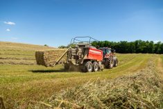 Red Hesston by Massey Ferguson large square baler with ejected bale in farm field. Photo: Agco