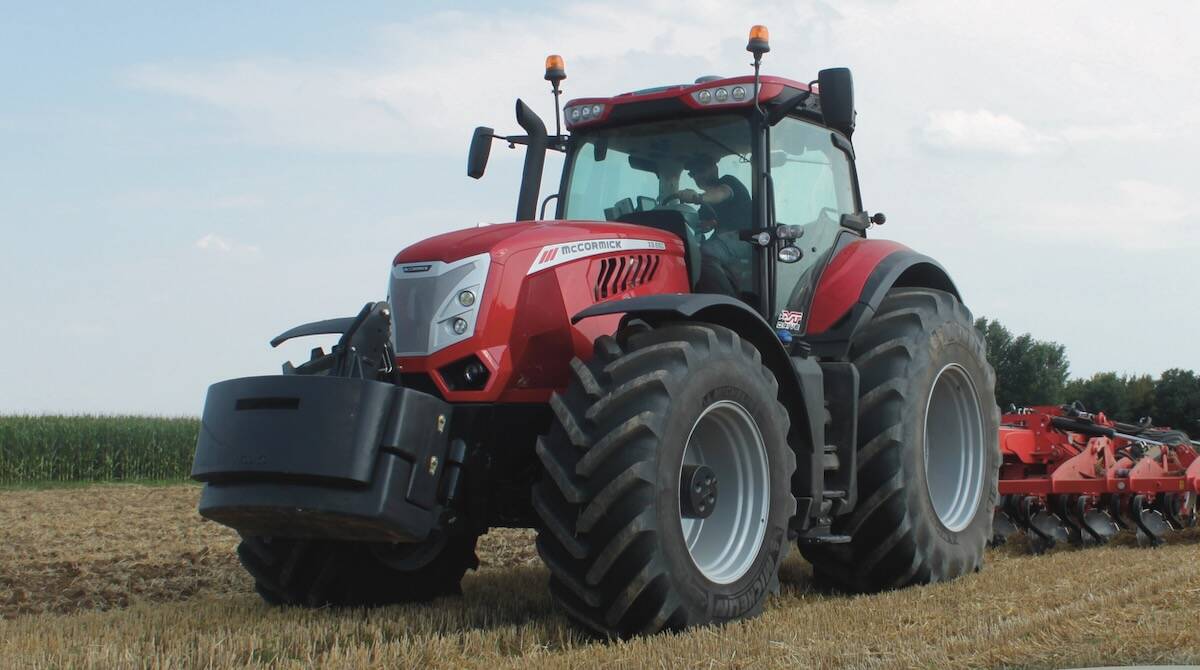 Red McCormick X8.680 tractor working in a stubble field with a rear-mounted implement, the brand's only model above 300 hp available in Canada. Photo: Scott Garvey