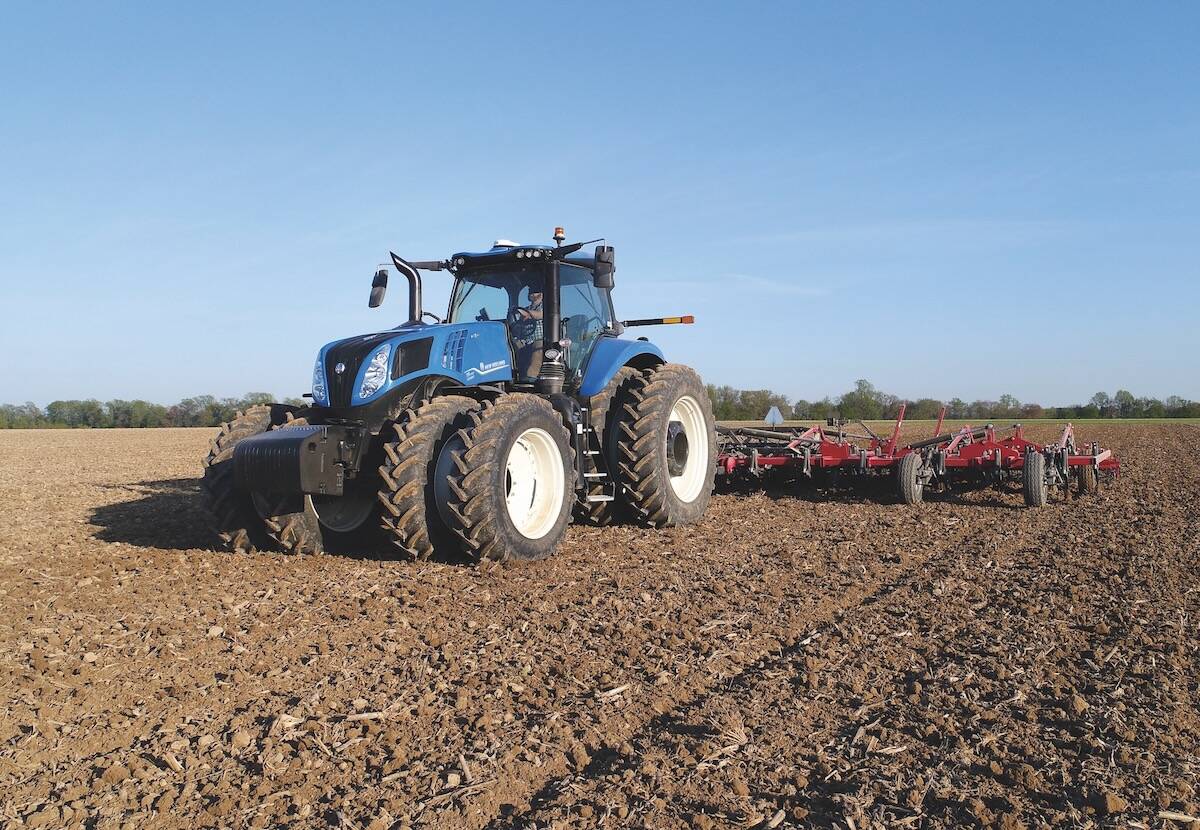 Blue New Holland T9.700 tractor pulling red tillage equipment through a worked field, offering up to 645 rated engine horsepower. Photo: Scott Garvey