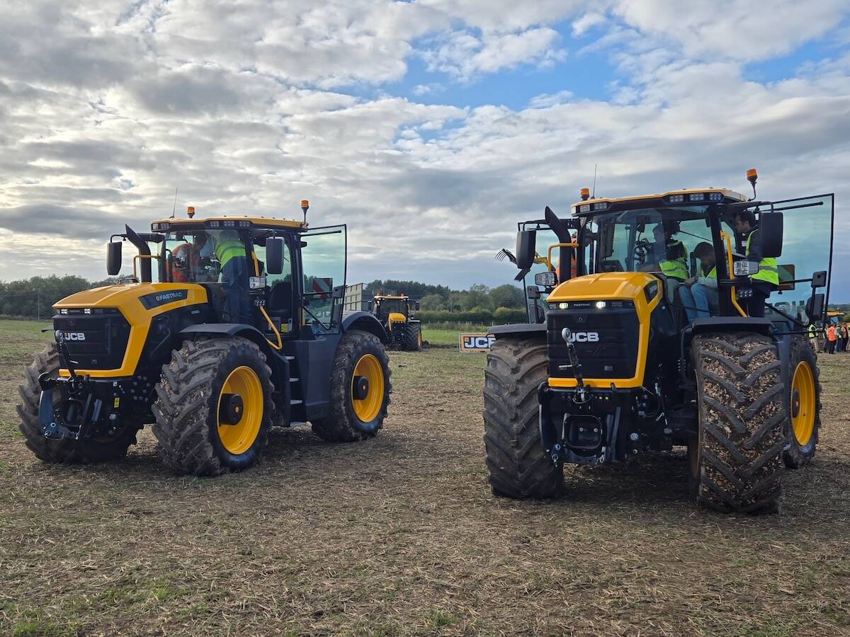 Two yellow and black JCB Fastrac 6000 Series tractors parked side by side at an outdoor farm event. Photo: Scott Garvey