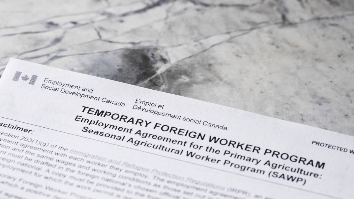 Close-up of a Canada Temporary Foreign Worker Program application form for the Seasonal Agricultural Worker Program, reflecting recent federal changes to rural worker caps. Photo: Getty Images Plus.