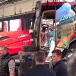A red Case IH Optum 440 tractor draws a crowd on the Agritechnica show floor in Germany, where the redesigned lineup made its world debut in November 2025.