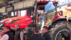 A red Case IH Optum 440 tractor draws a crowd on the Agritechnica show floor in Germany, where the redesigned lineup made its world debut in November 2025.