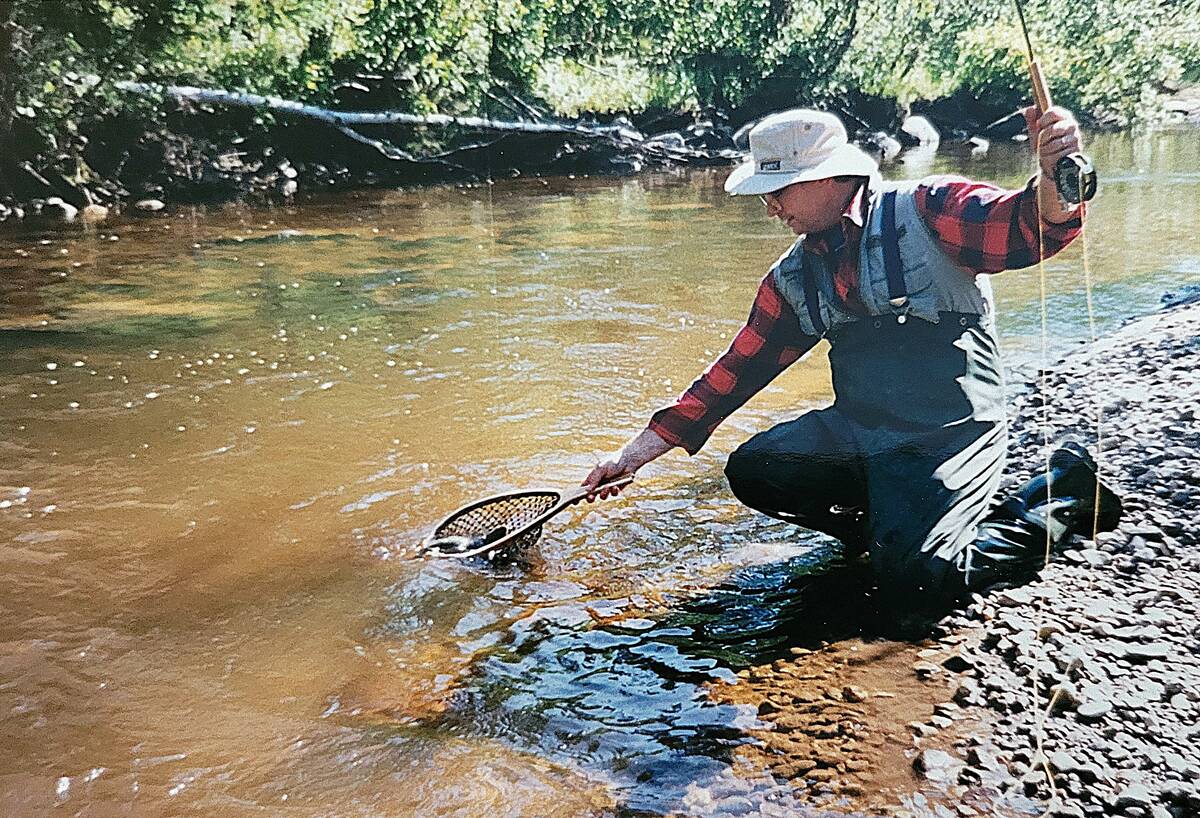 A younger Tim Sopuck lands a trout from a stream in the Duck Mountains in Manitoba.